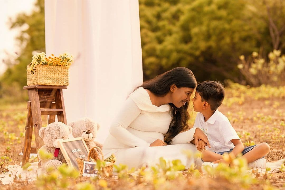 Outdoor maternity portrait at golden hour with family