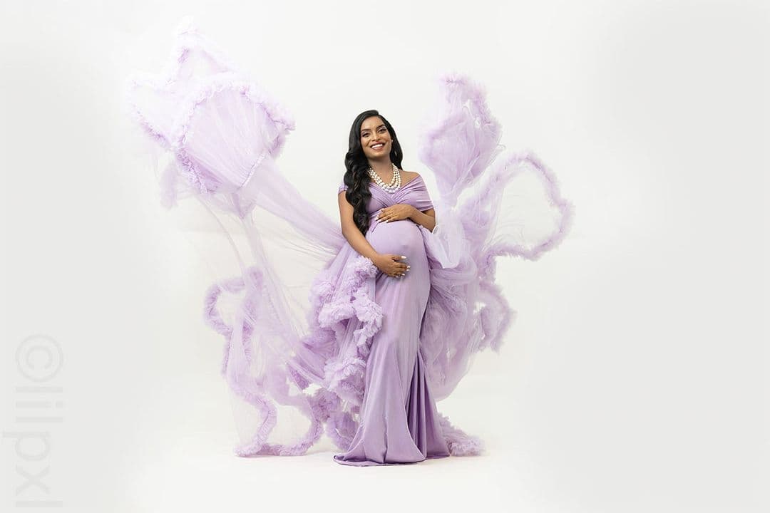 Wide fine-art maternity portrait with lavender tulle billowing outward