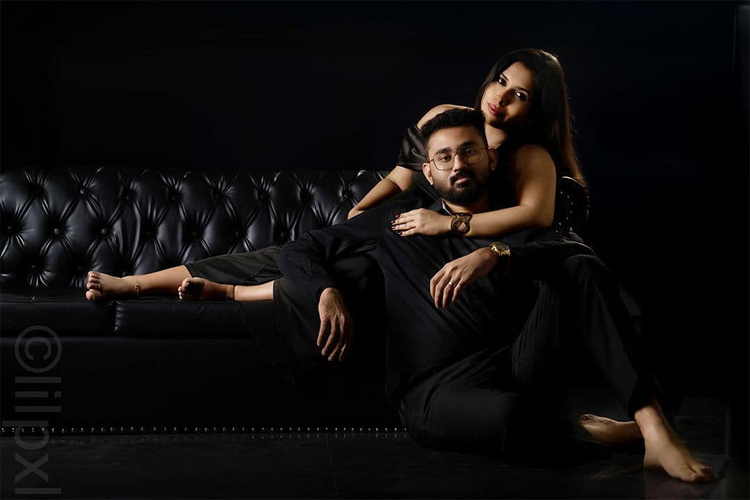 Couple portrait in dark, moody studio lighting