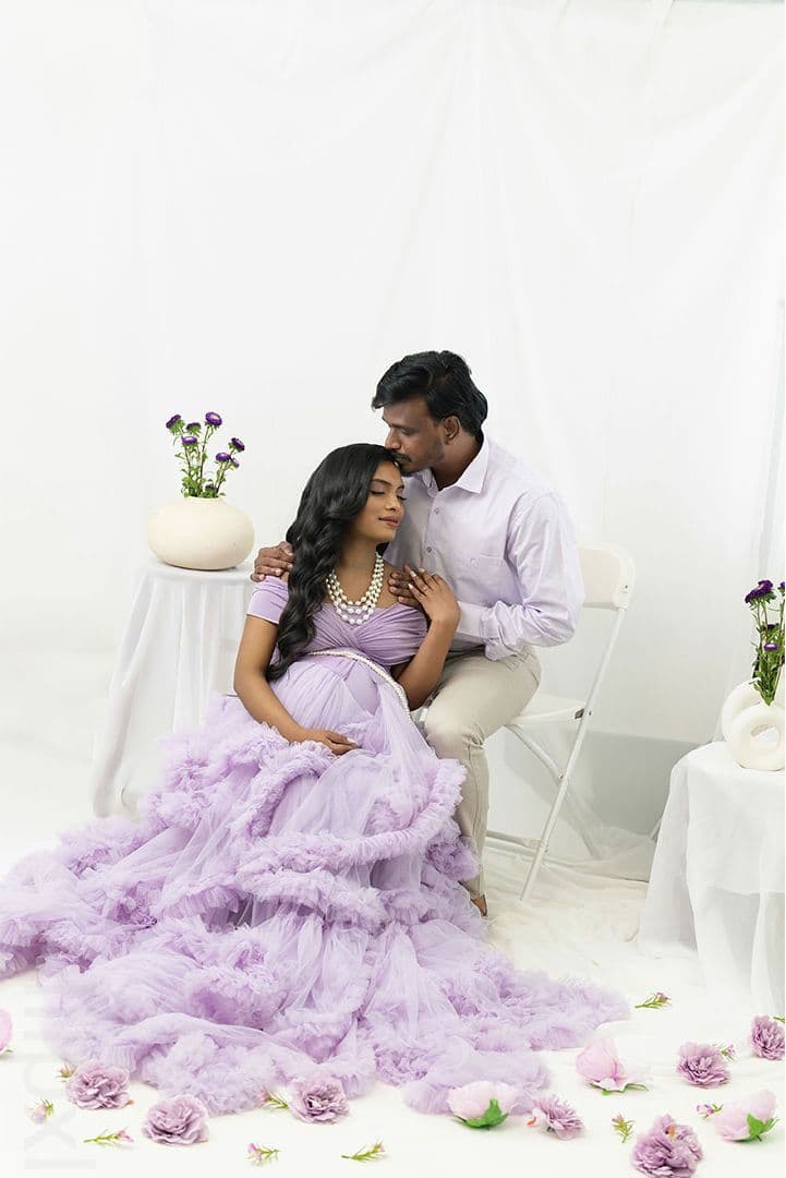 Couple portrait, maternity in a lilac ballgown seated together
